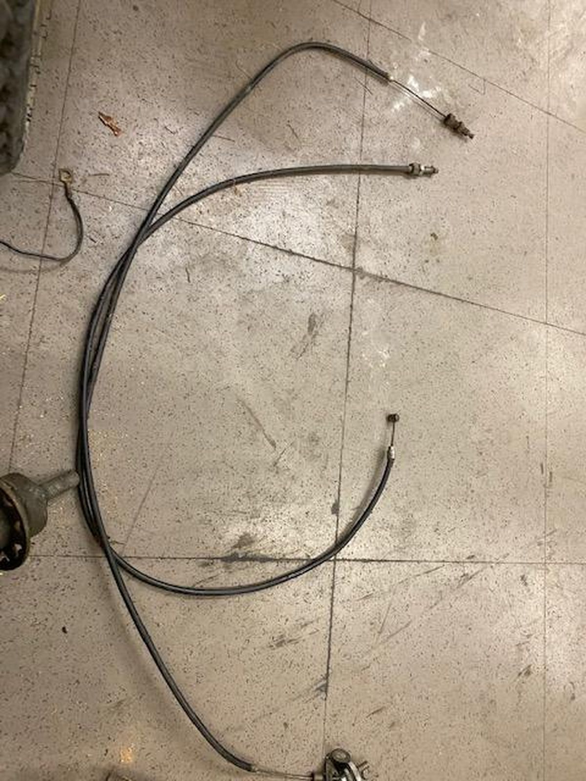 A close up of a hose on a tiled floor.