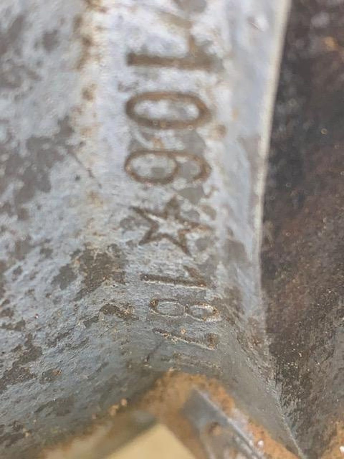 A close up of a piece of metal with a number on it.