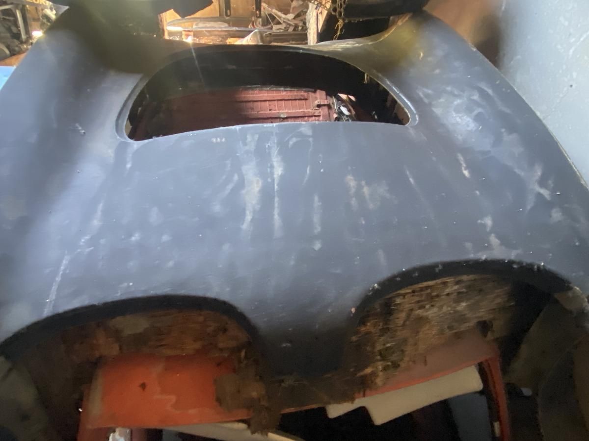 The hood of a car with a hole in it