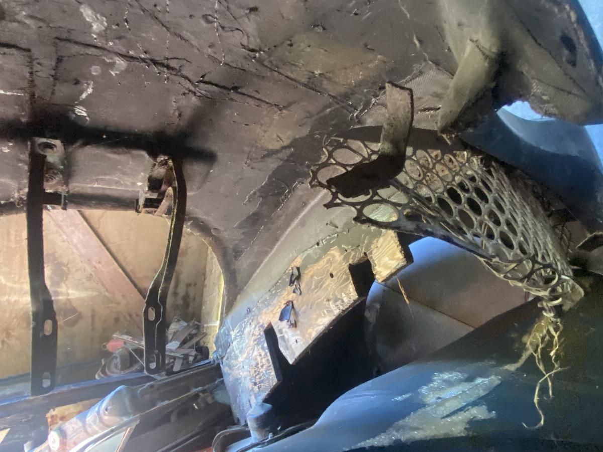 A close up of a car hood with a net hanging from it.