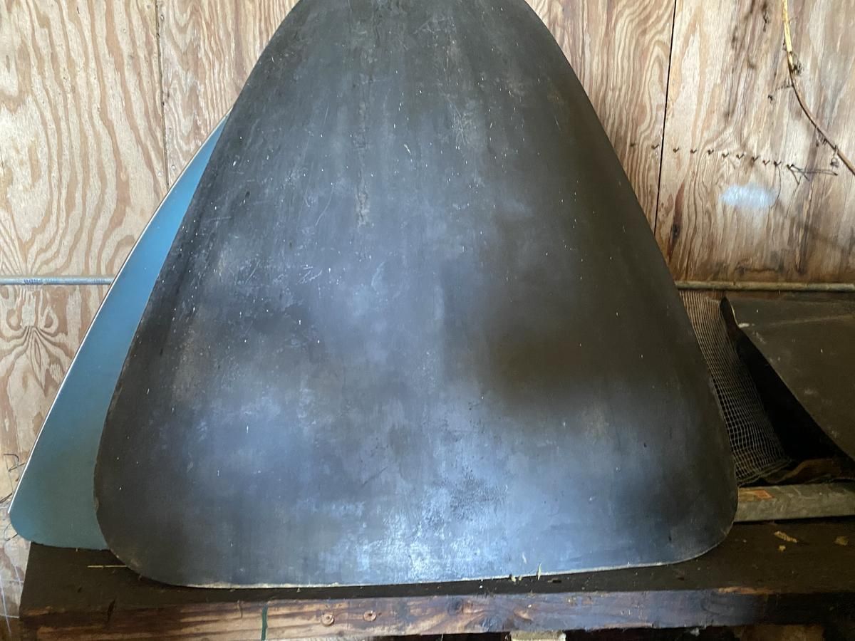 A large metal object is sitting on top of a wooden table.