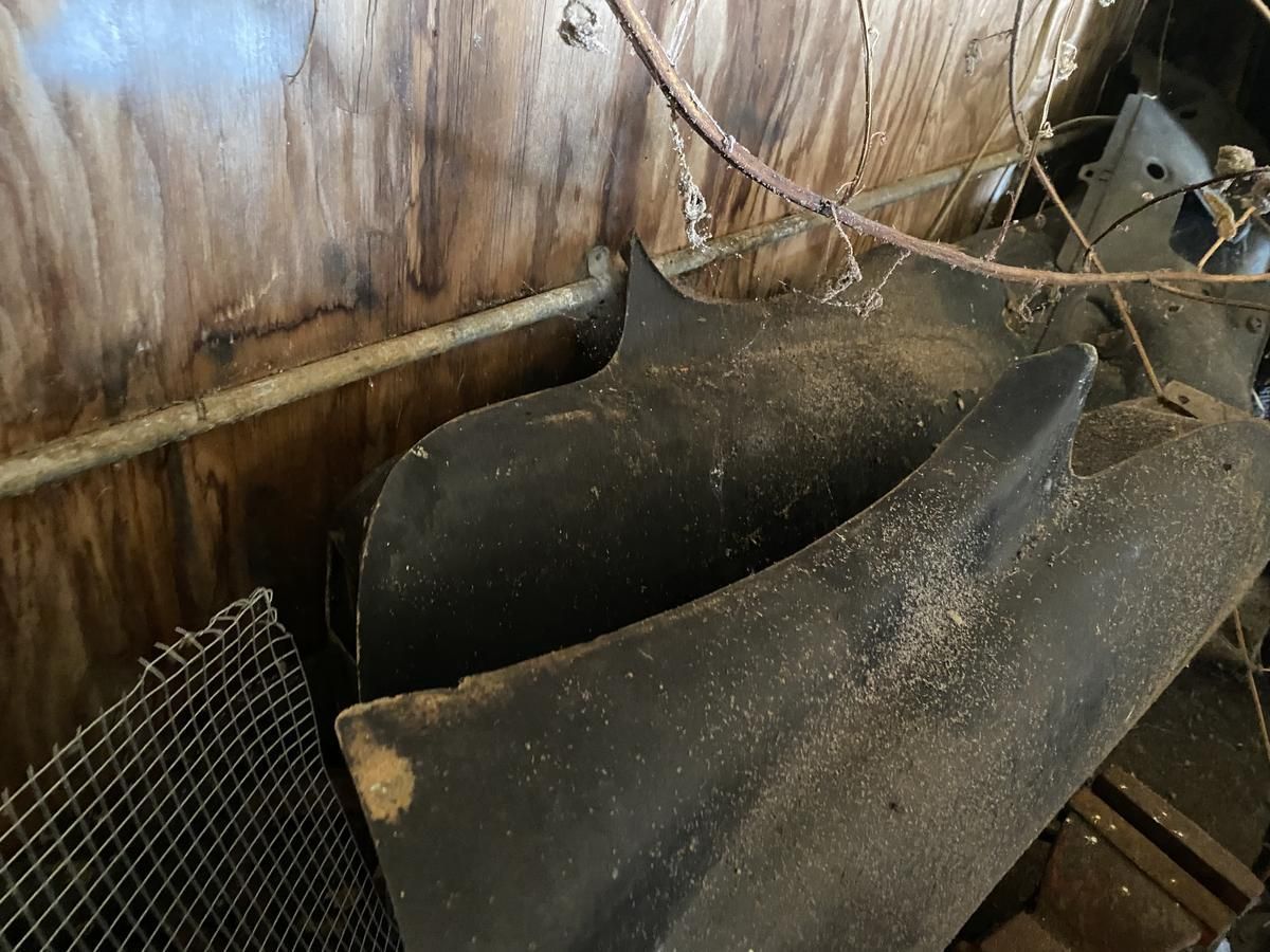 A bunch of pieces of metal are sitting on top of each other in a room.