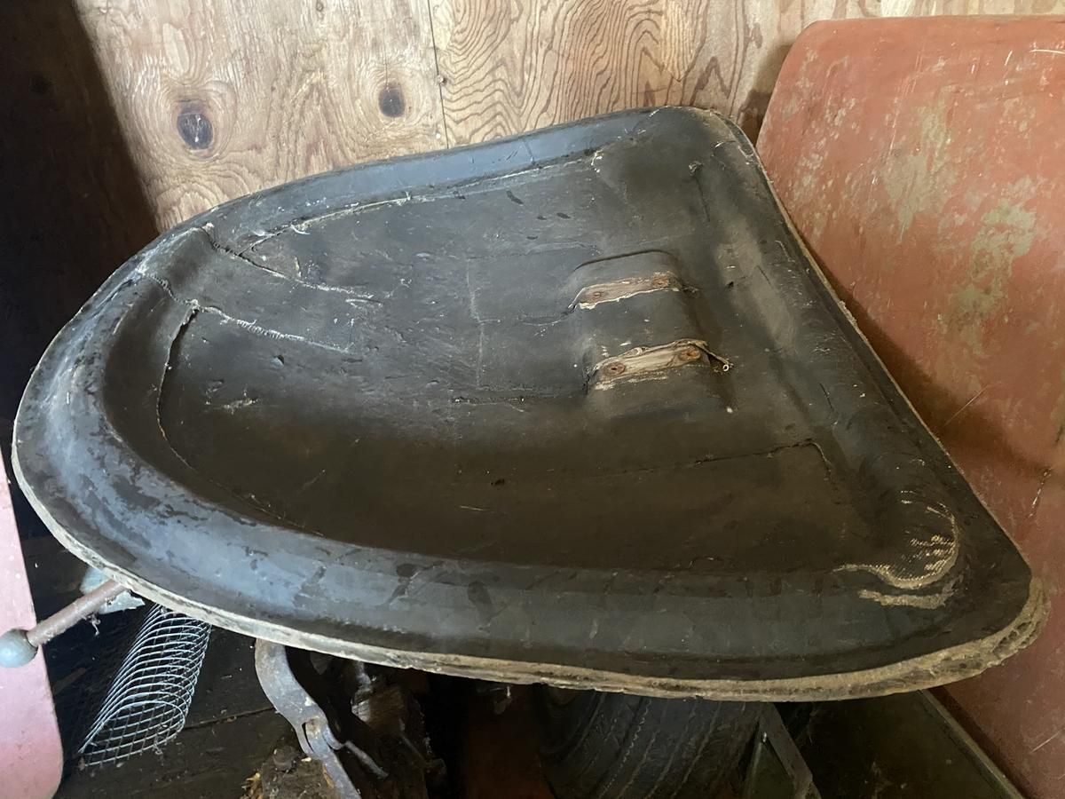 A black sink is sitting on top of a wooden table.