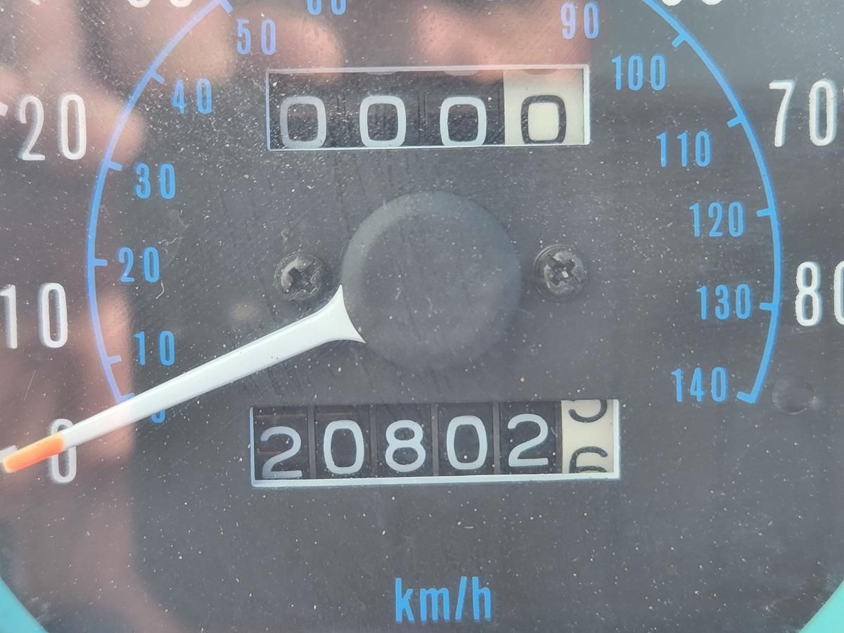 A close up of a speedometer with the number 20802 on it