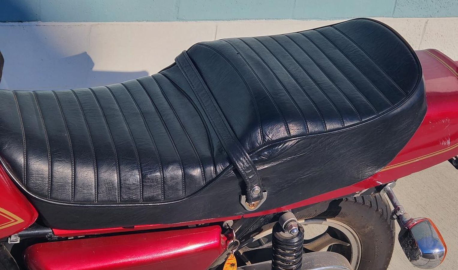 A red and black motorcycle with a black seat