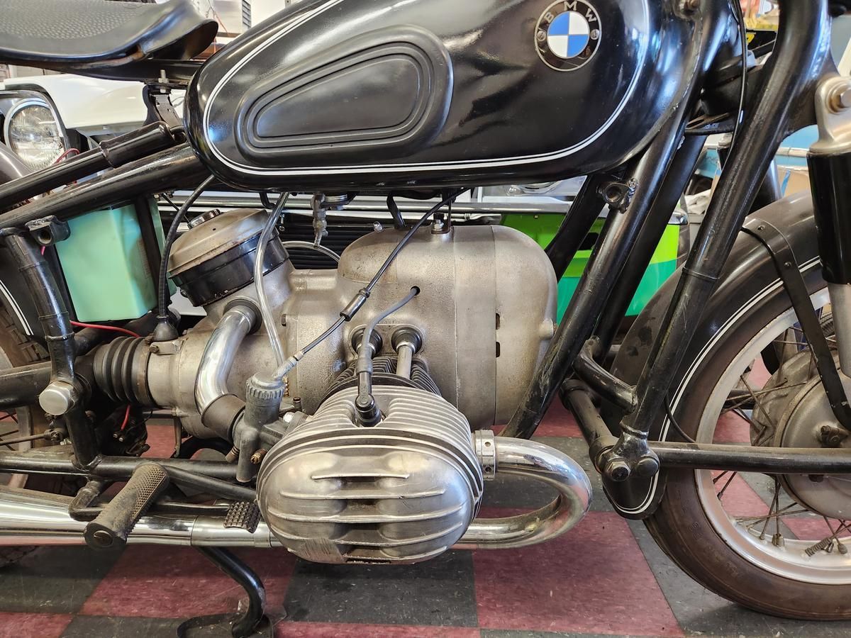 A black bmw motorcycle is parked in a garage.