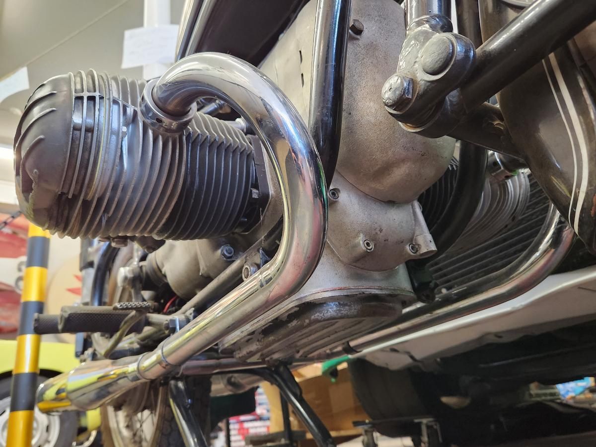 A close up of a motorcycle engine in a garage.