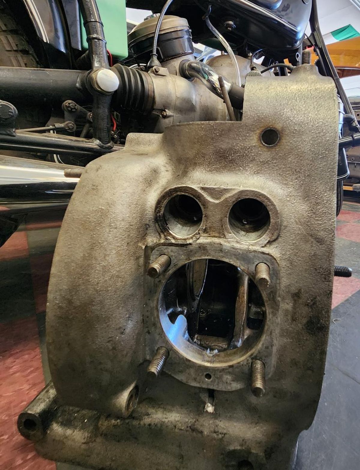 A close up of a motorcycle engine with a hole in it.