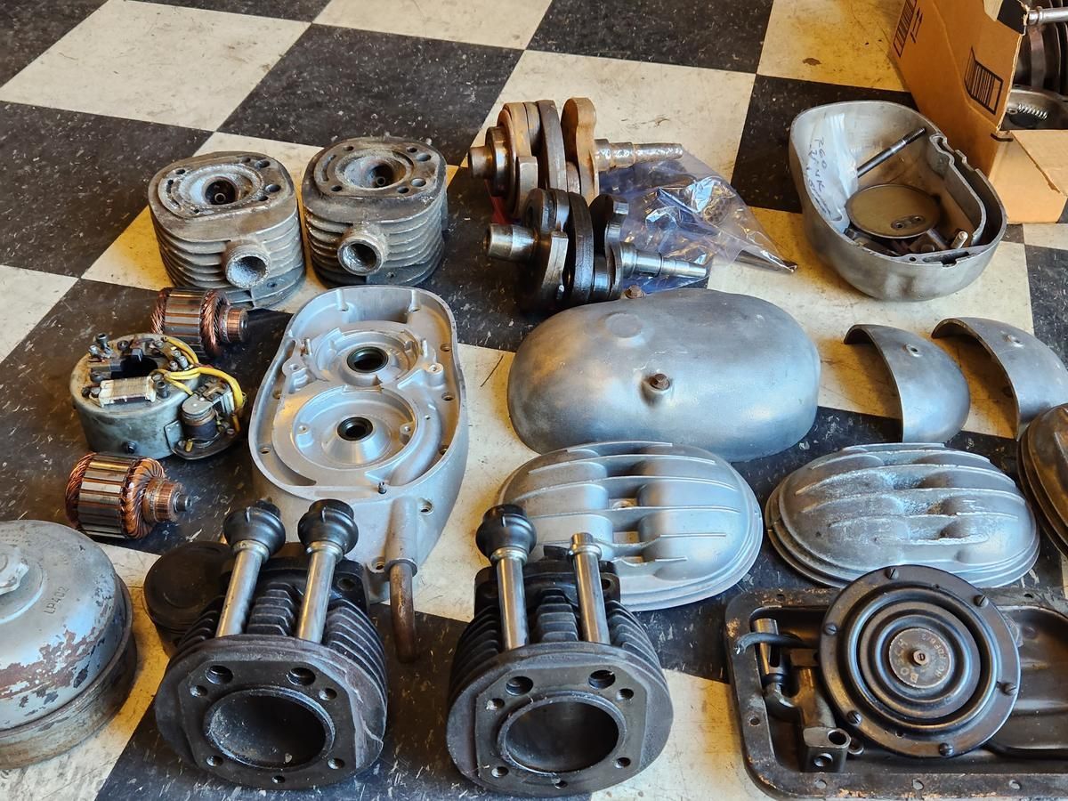 A bunch of motorcycle parts are sitting on a checkered floor