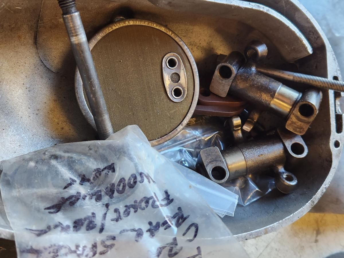 A bag of parts is sitting on top of a metal container.