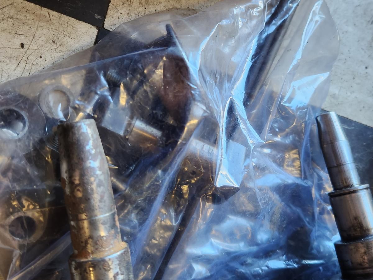 A bunch of metal parts are wrapped in plastic