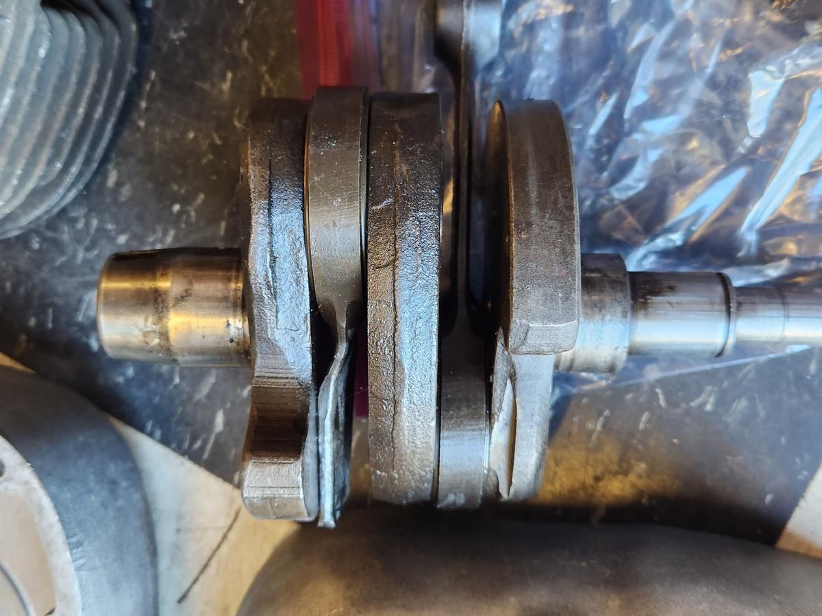 A close up of a crankshaft on a table.