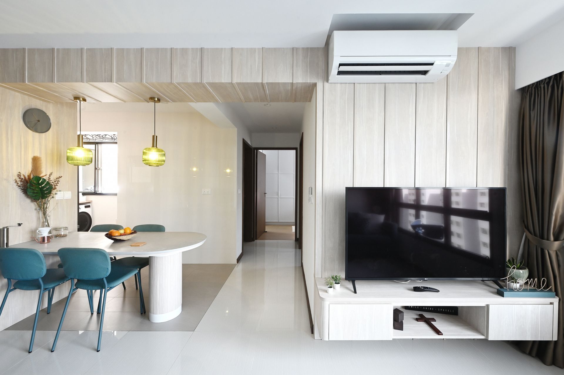 A living room with a table and chairs and a flat screen tv