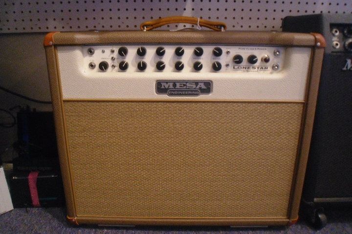 Vintage tan guitar amplifier with silver control panel and handle on top