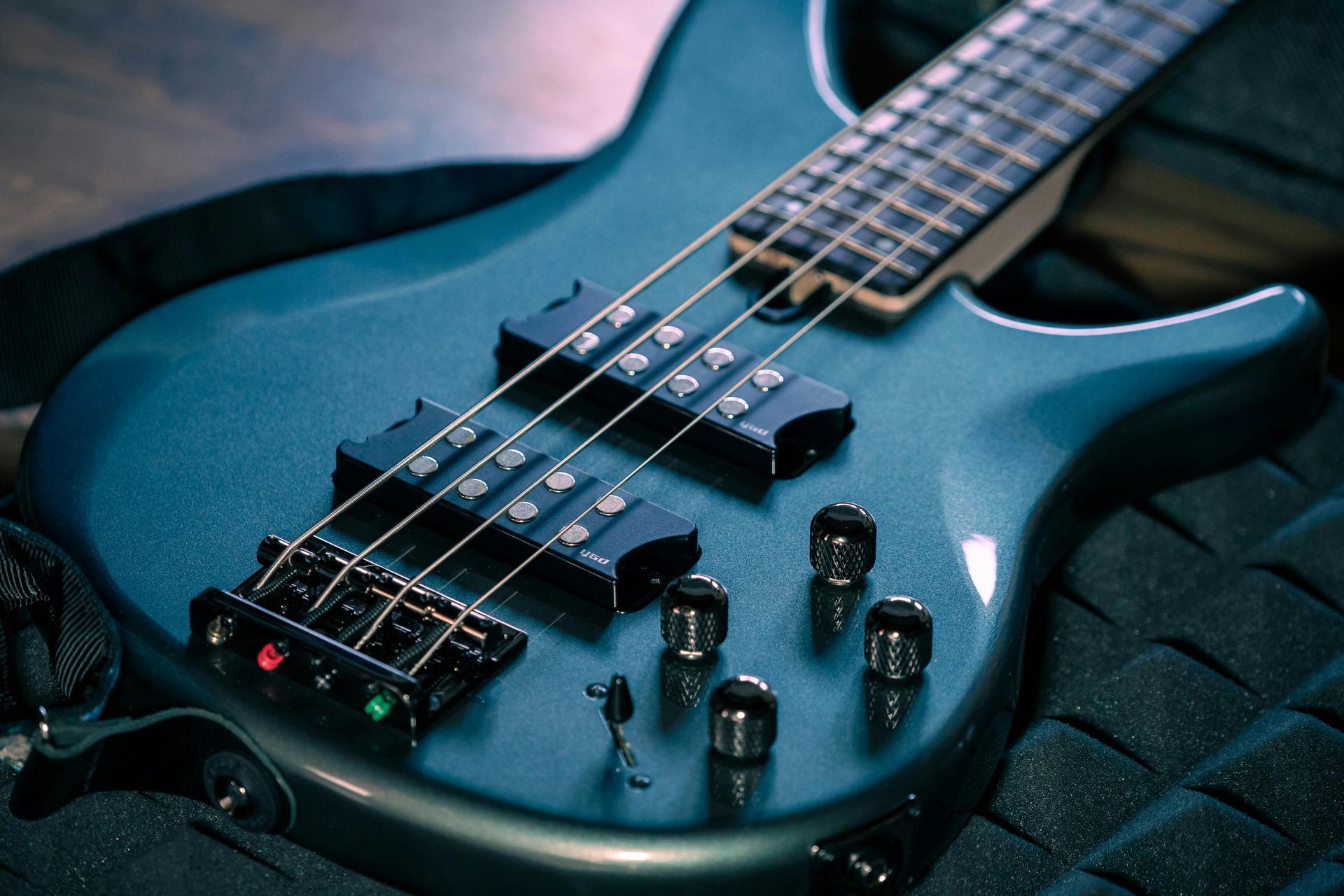Two electric guitars and amplifiers in a music store display, with a natural wood guitar centered.
