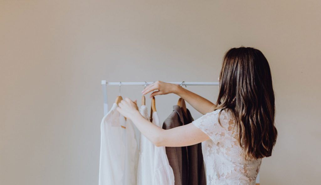 Sally Flower organising the home by hanging clothes up