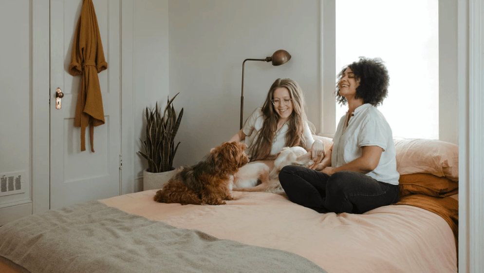 two women at home on a bed in appreciation oh home