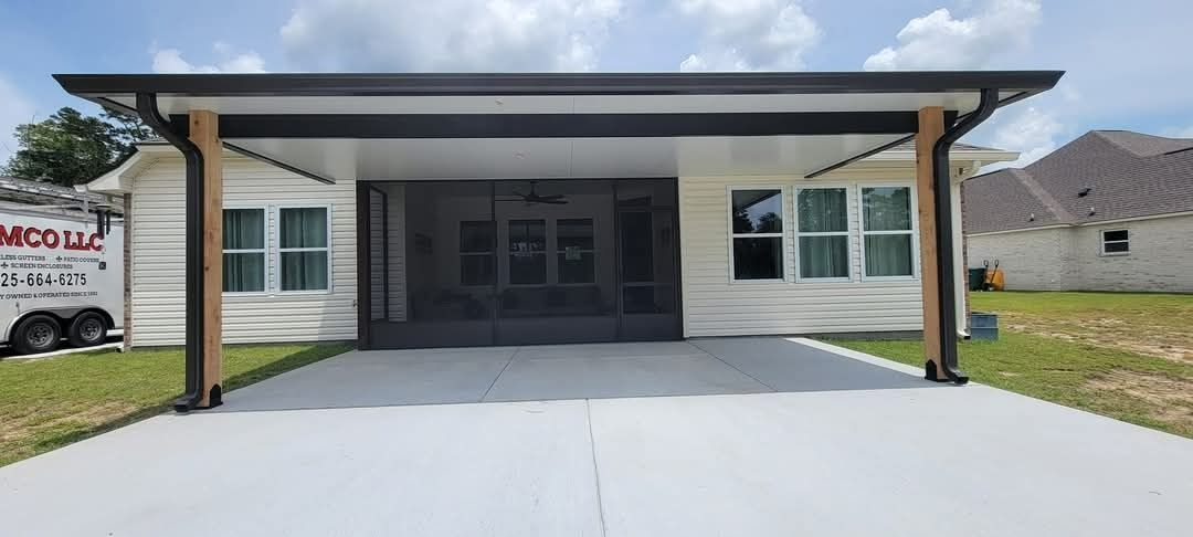 Modern white house front with covered porch and two dark columns over a concrete driveway