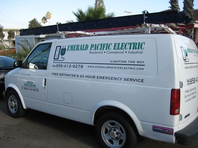 White utility van for Emerald Pacific Electric parked outdoors, with company logo and phone number on the side.