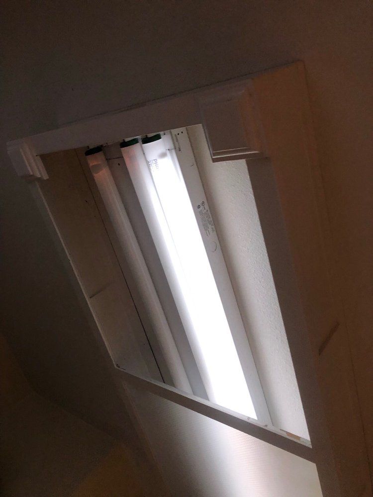 Tilted view of a window blind with bright daylight shining through slats