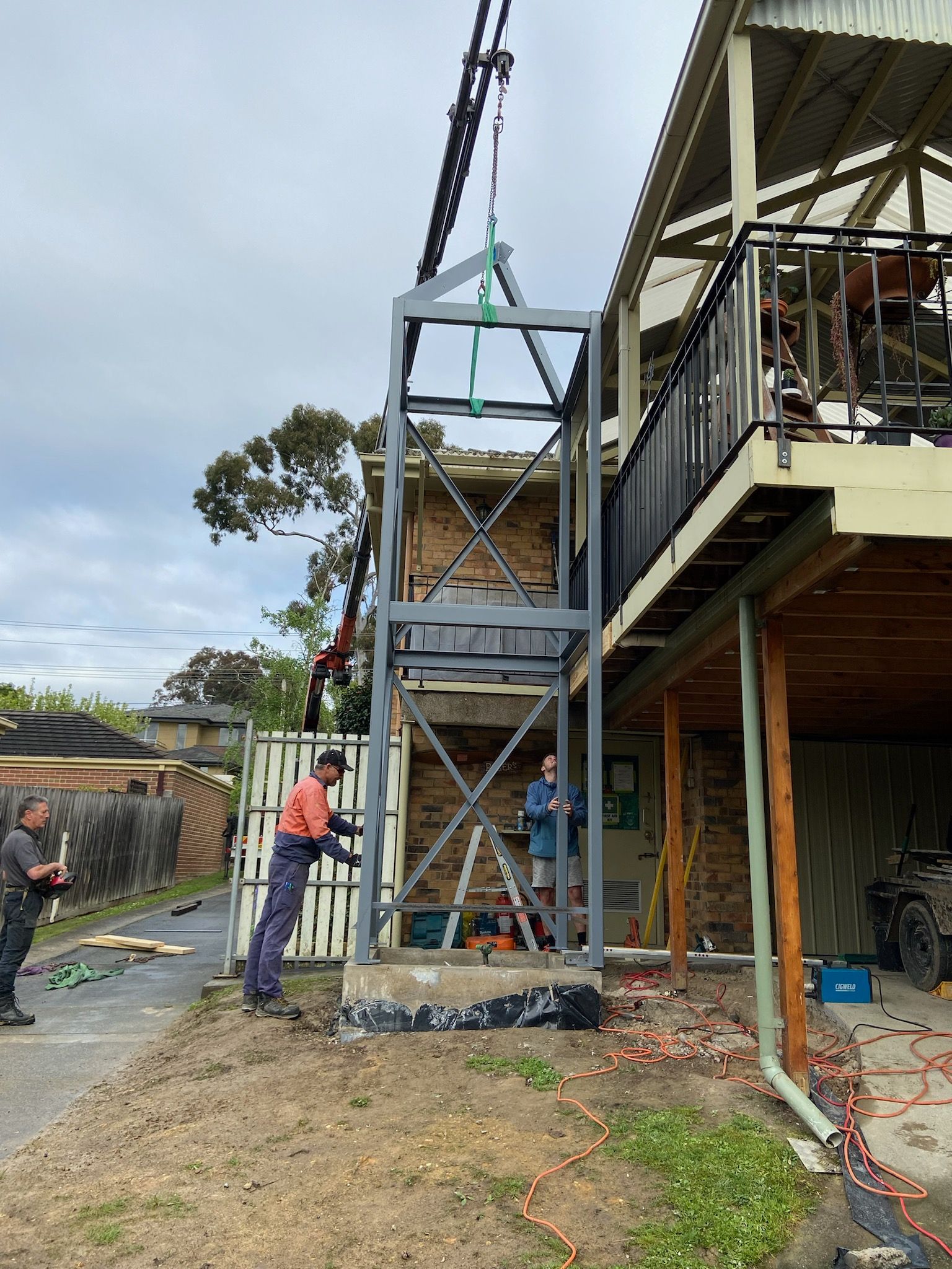Construction Workers Installing A Gray Elevator