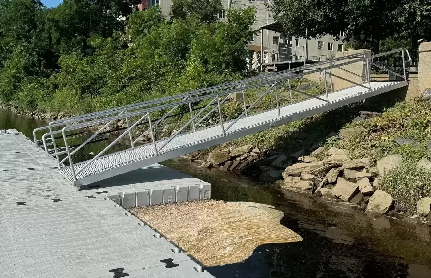 A bridge over a river with a dock in the background.