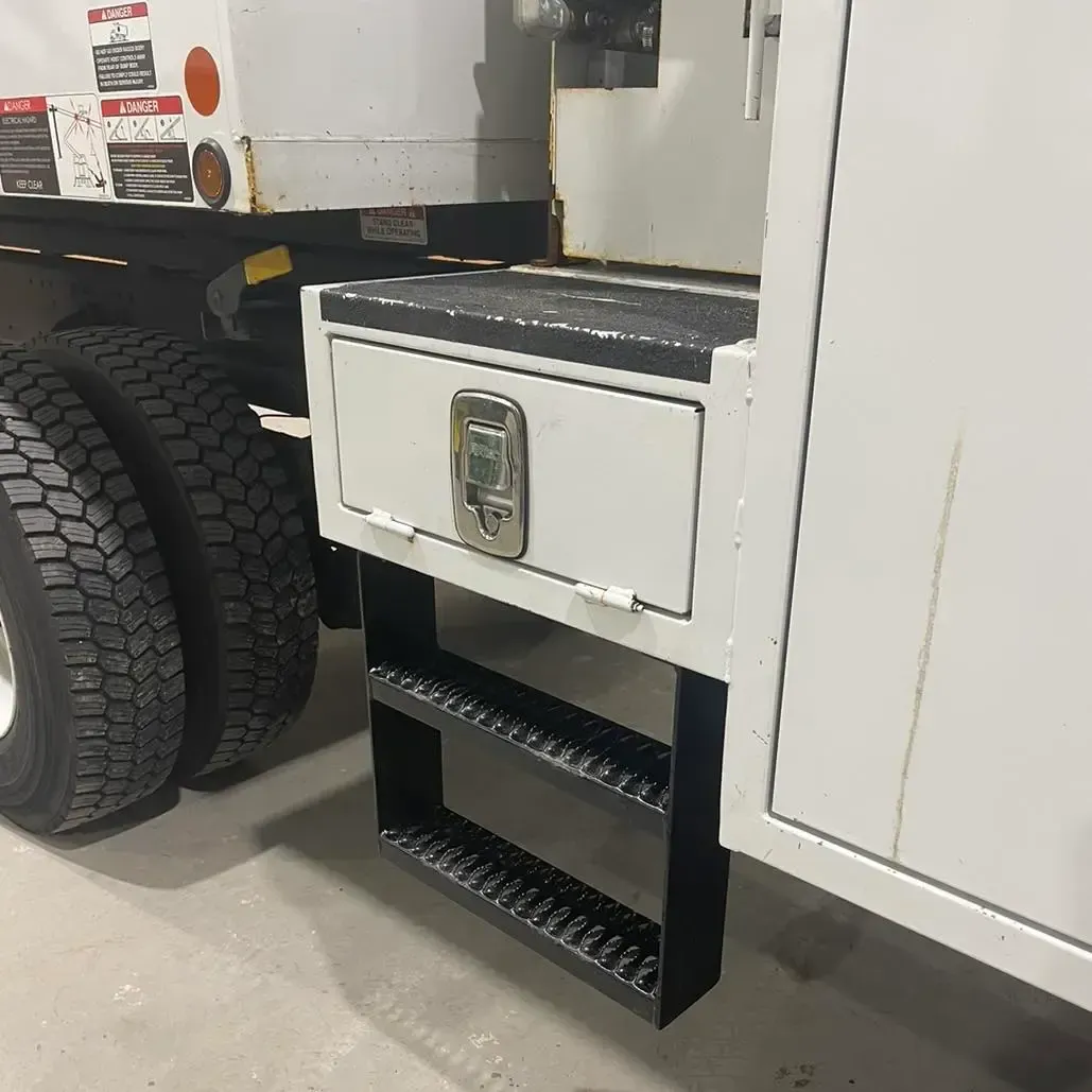 A white truck with a ladder attached to the side of it.