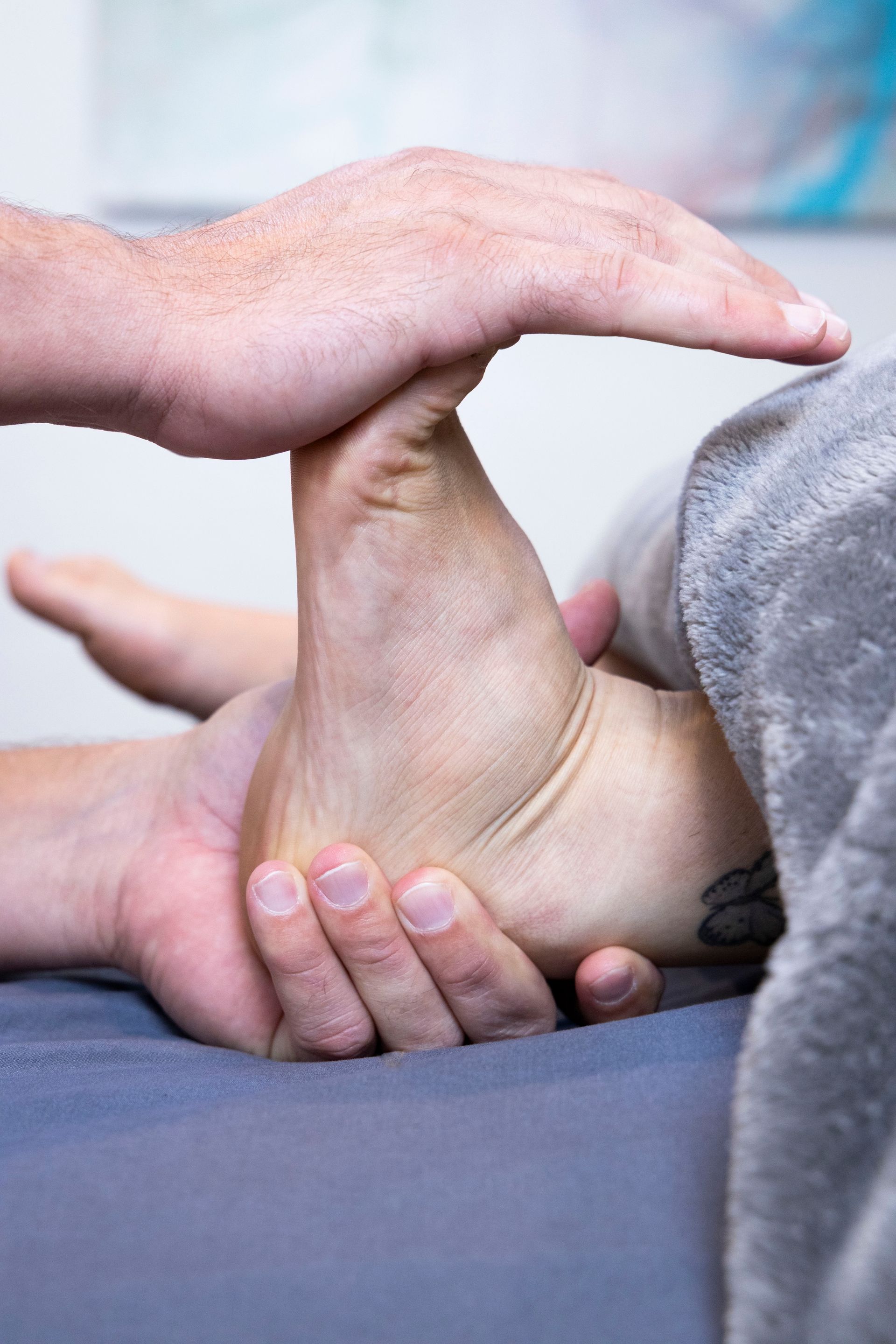 Polarity and reflexology therapy on a foot