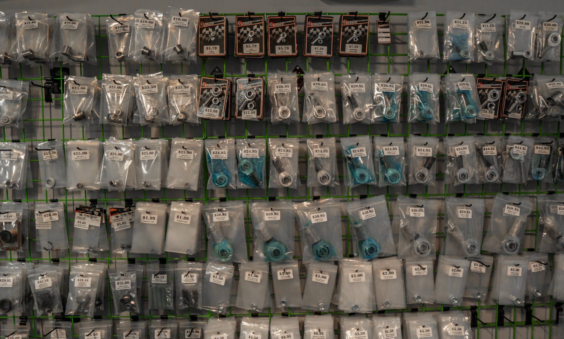 Wall display of packaged hardware items, including fasteners and connectors.