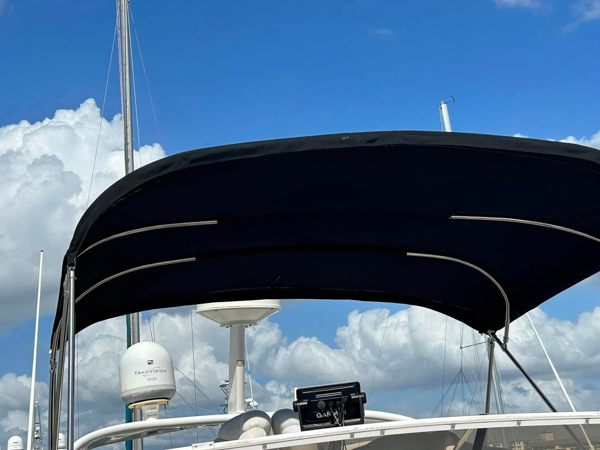 Blue boat bimini top against a partly cloudy sky.