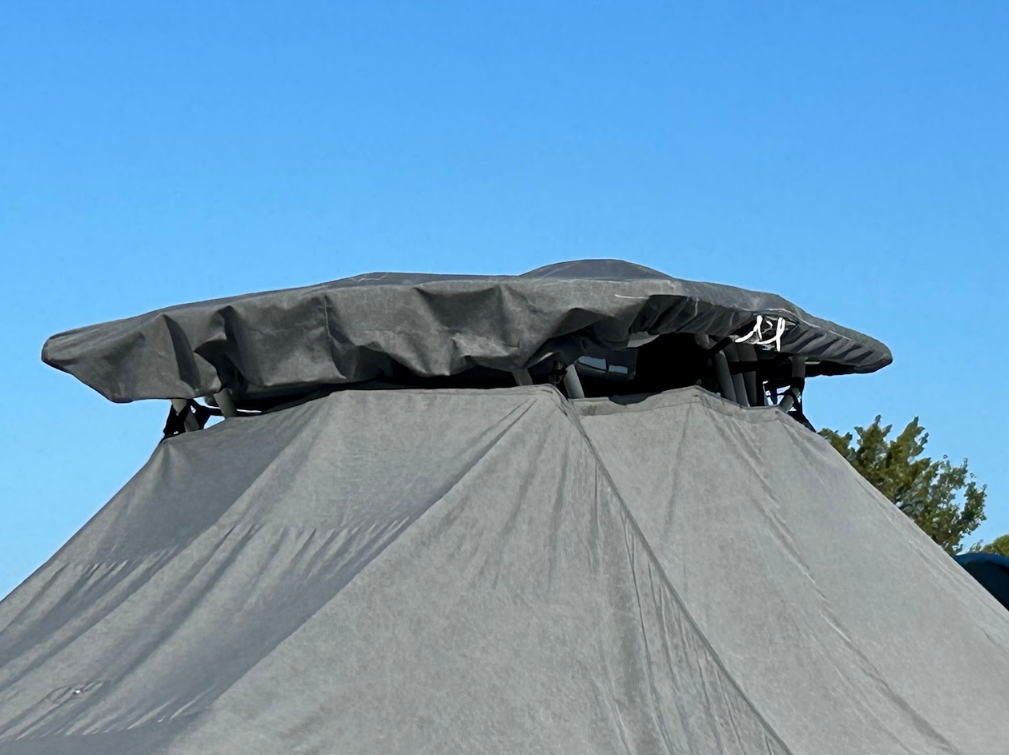 Gray gazebo with a dark gray top against a clear blue sky.