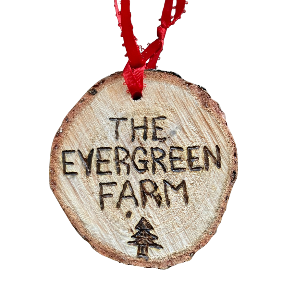 A wooden ornament that says the evergreen farm