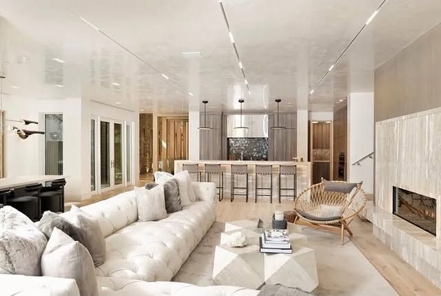 A living room filled with furniture and a fireplace.