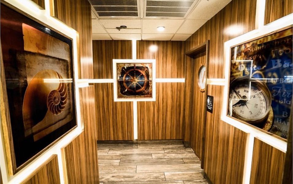 A hallway with wooden walls and a clock on the wall
