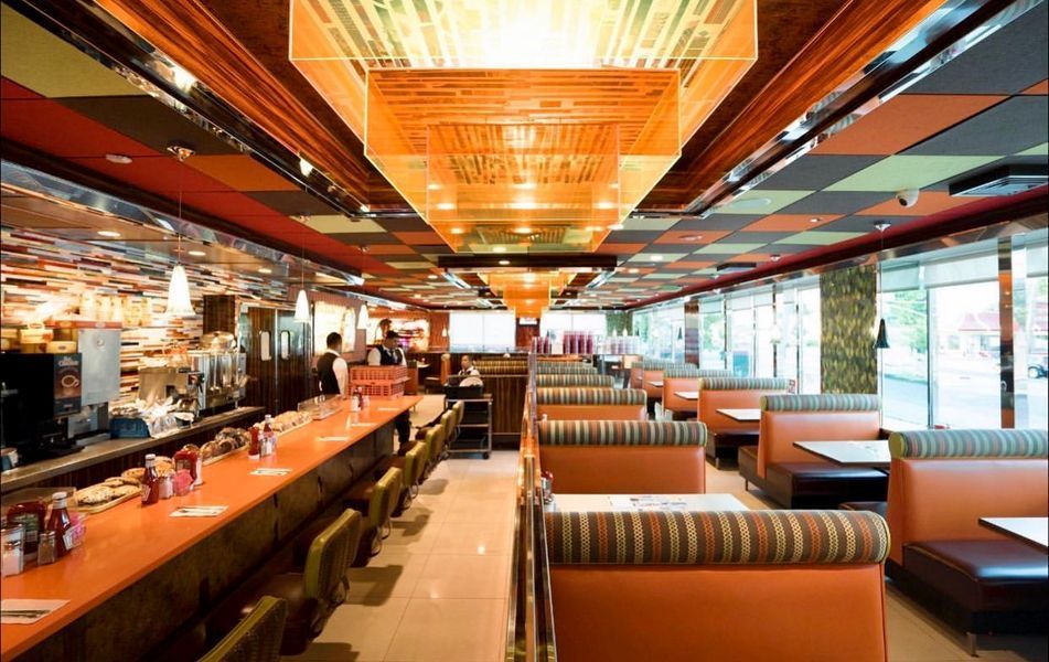 A diner with tables and chairs and a long counter
