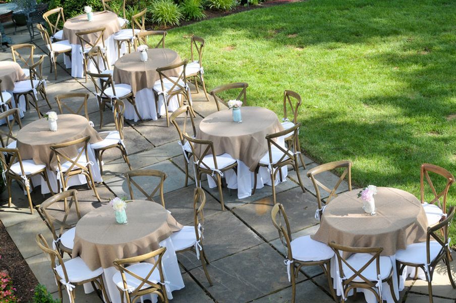 A patio with tables and chairs set up for a party
