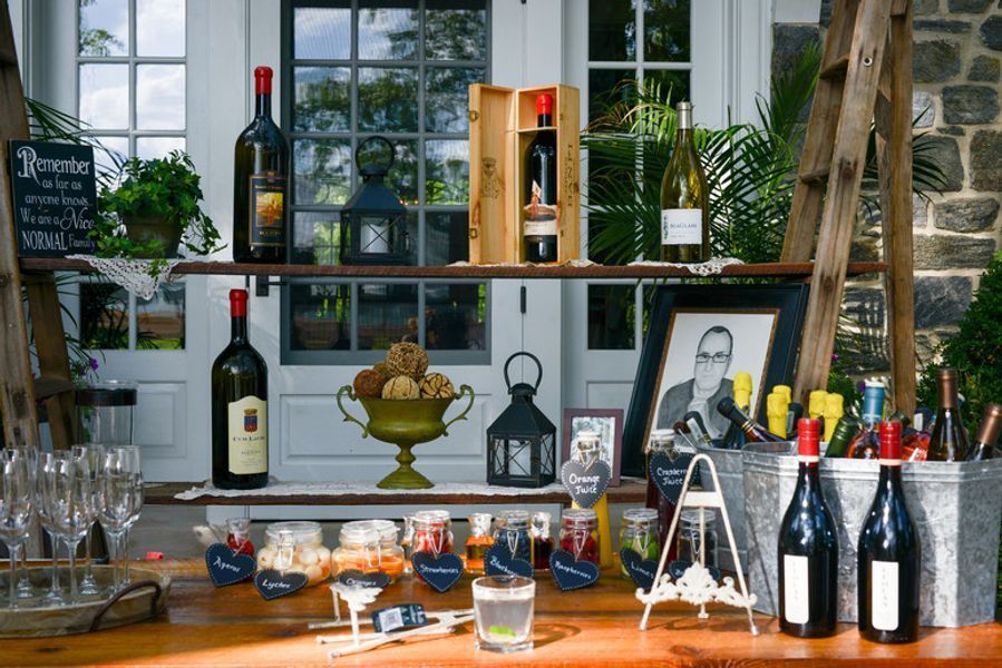 A wooden bar with bottles of wine and glasses on it