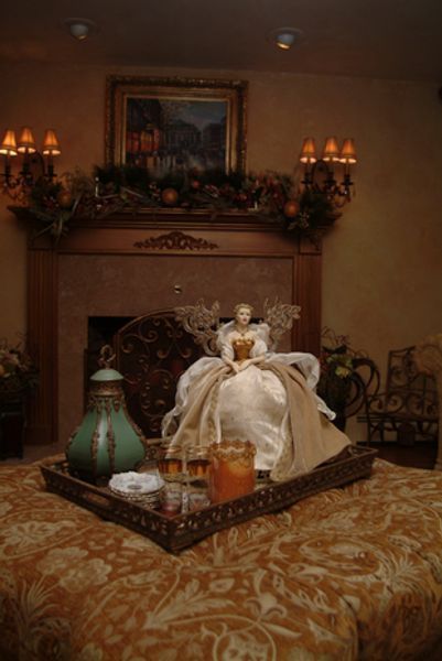 A tray with a doll on top of it in front of a fireplace