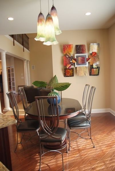 A dining room with a glass table and chairs