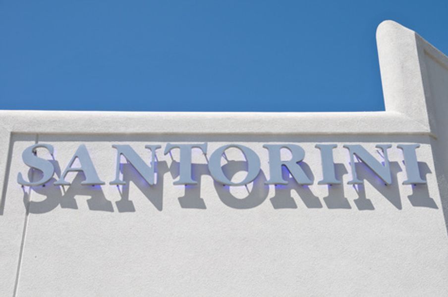 A white building with the word santorini on it