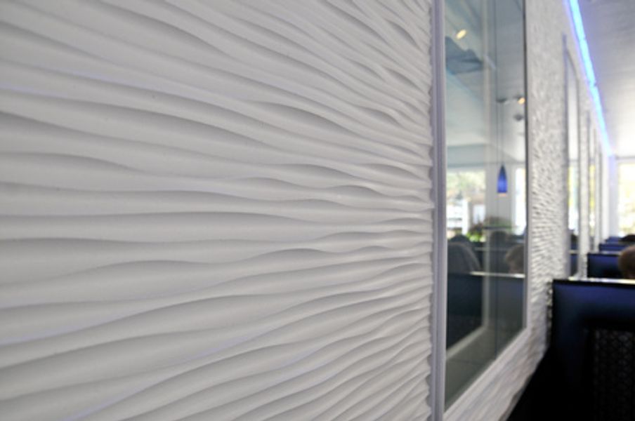 A white wall with a striped pattern is in a restaurant