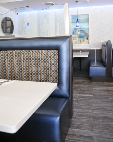 A restaurant with blue booths and a white table