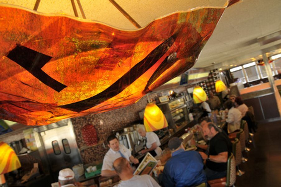 A group of people are sitting at a table in a restaurant