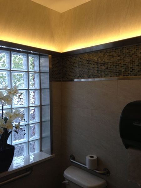 A bathroom with a toilet and a window