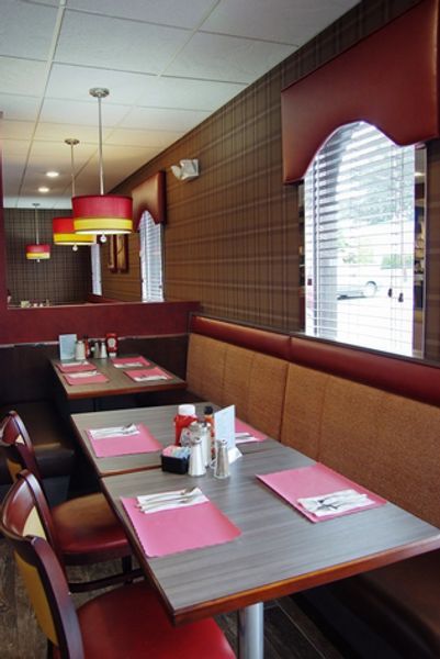 A diner with tables and chairs and a window