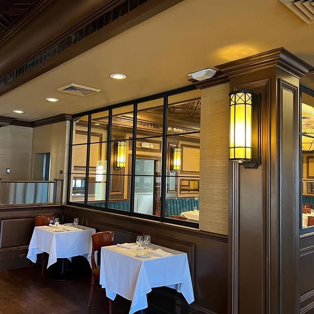 A restaurant with tables and chairs and a large window