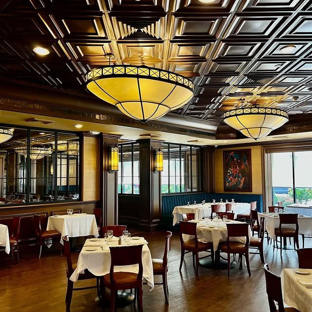 A large dining room with tables and chairs and lots of lights