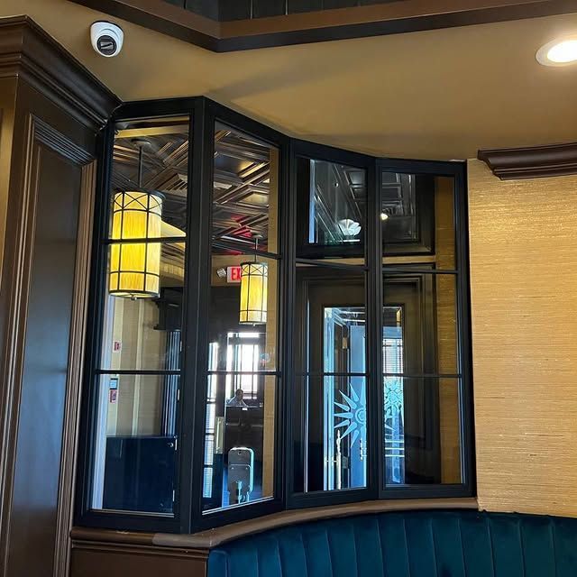 A room with a lot of windows and a sign that says exit