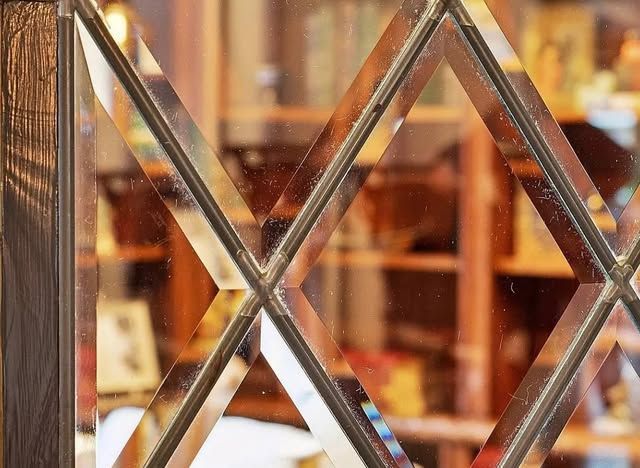 A close up of a stained glass window with a blurred background.
