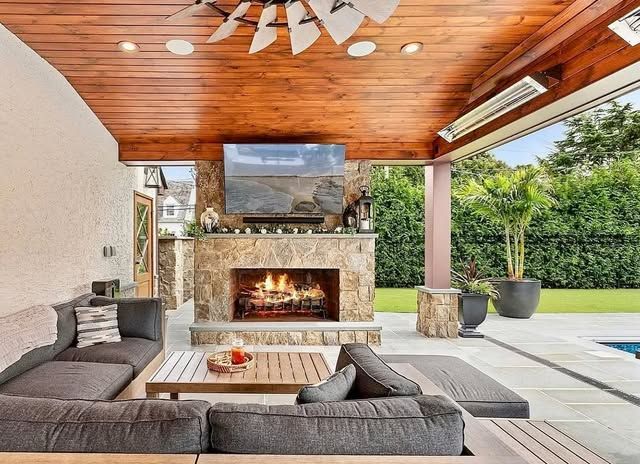 A living room with a fireplace and a flat screen tv